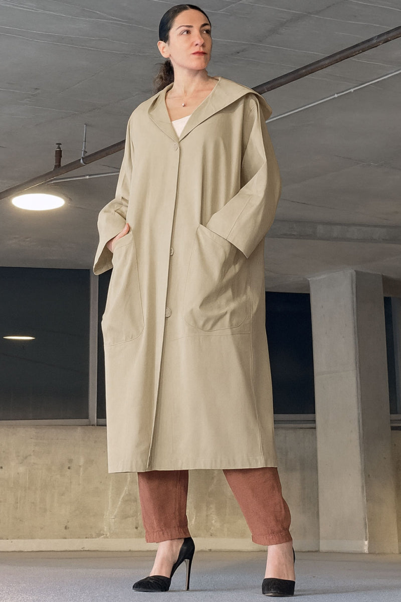 Oversized beige water-resistant windbreaker jacket with waterproof design and attached hood
