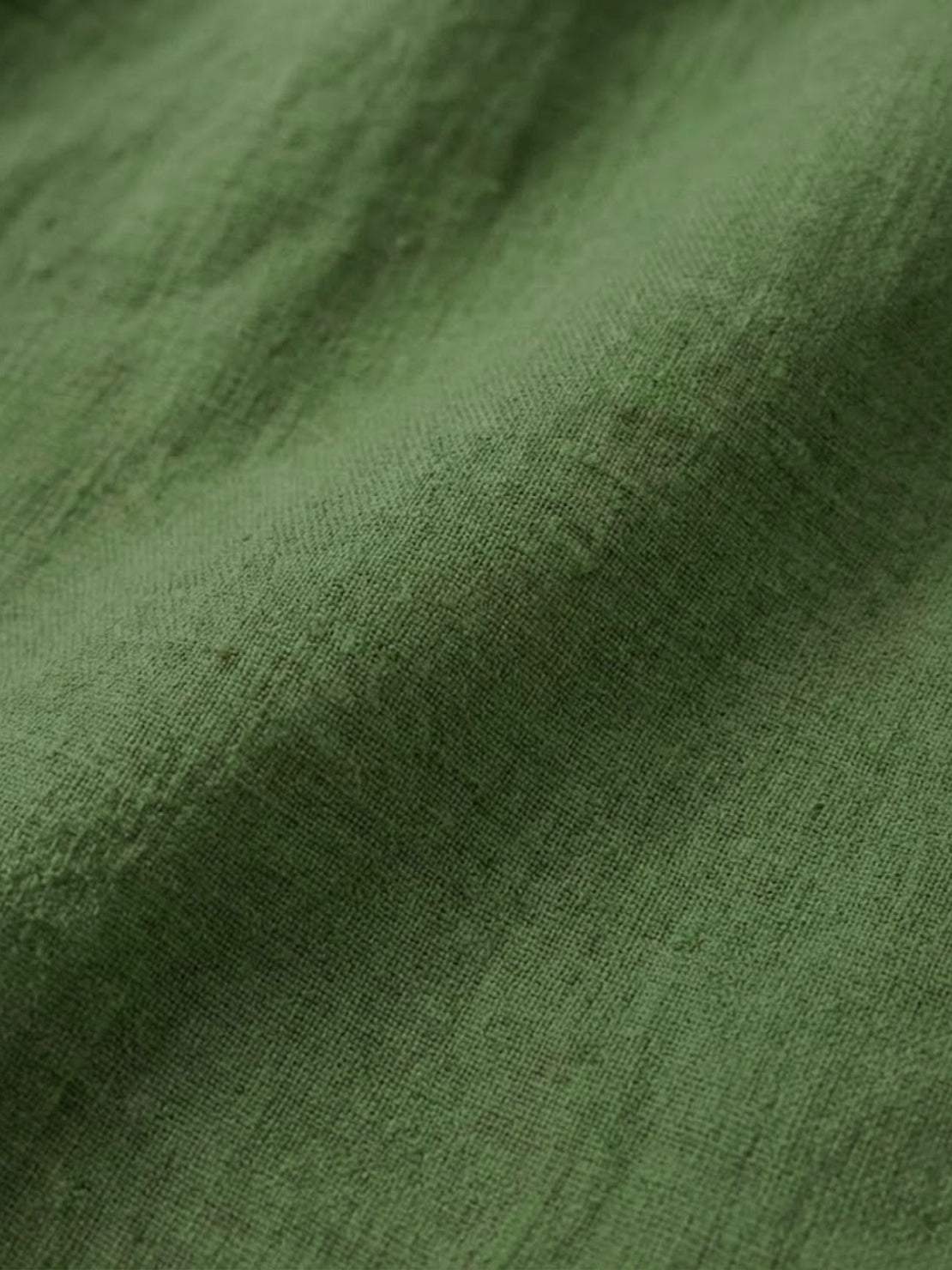 white pure linen age-defying shirt with button detail on a wooden rack