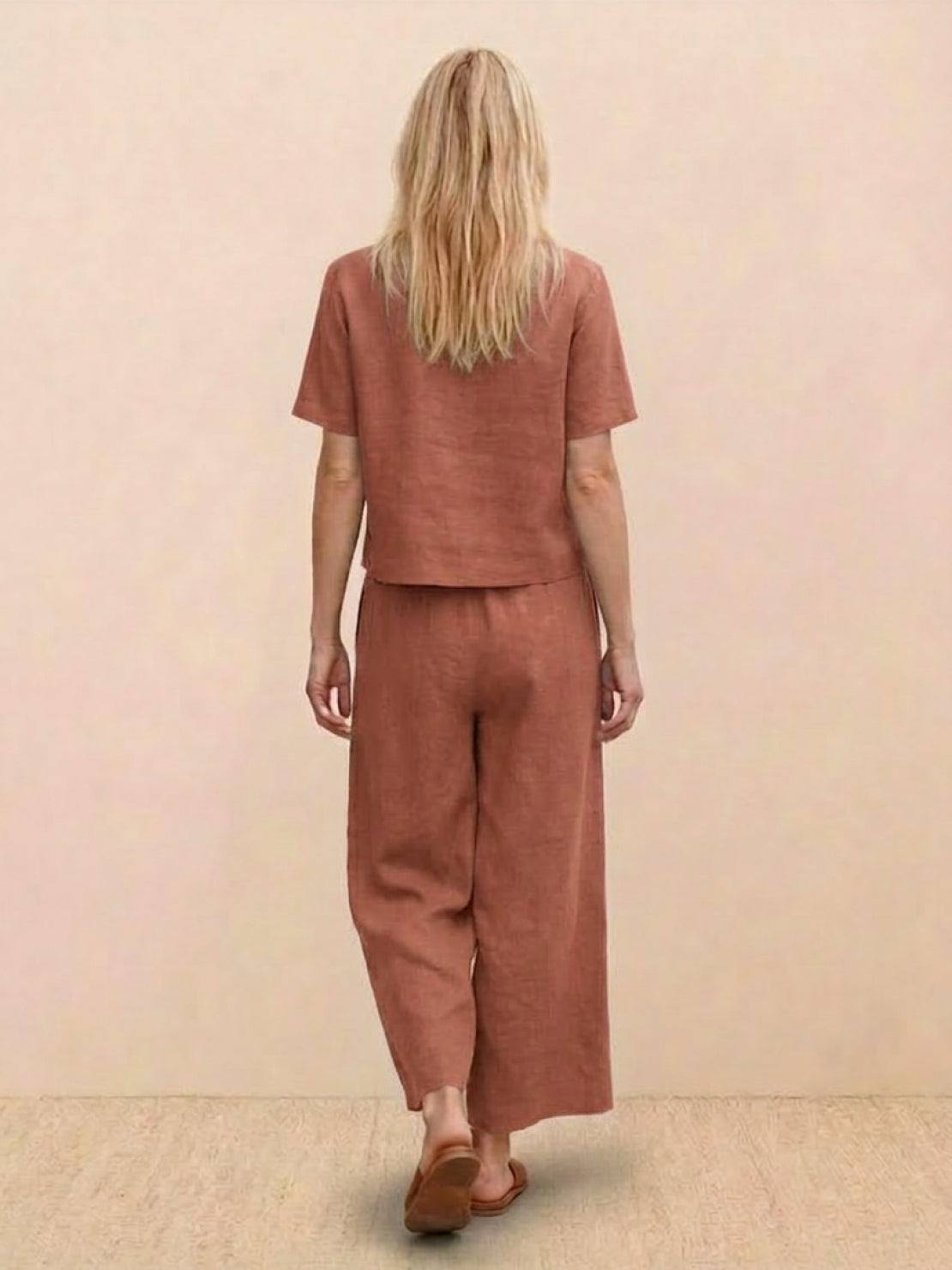 woman wearing a relaxed loose fit co-ord set with soft-tailored top and wide-leg bottoms in solid color