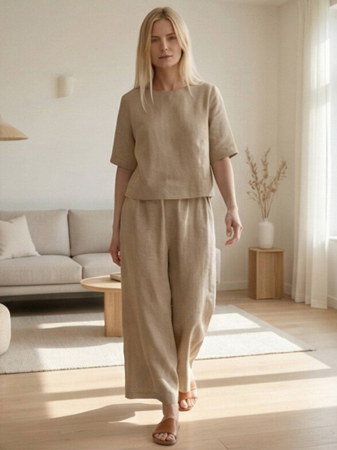 woman wearing loose fit co-ord set with wide-leg trousers and soft-tailored top in neutral color