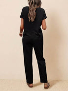 Woman wearing black 100% cotton total comfort two-piece travel set, breathable and wrinkle-resistant.