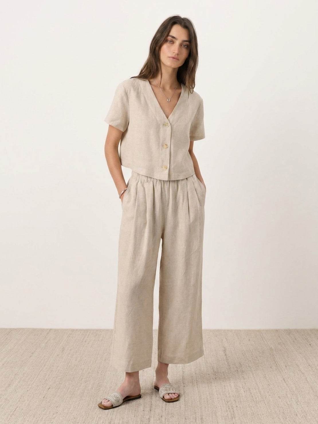 Lightweight 100% linen French top with V-neck, short sleeves, three-button front, and relaxed boxy fit in light khaki and off white colors