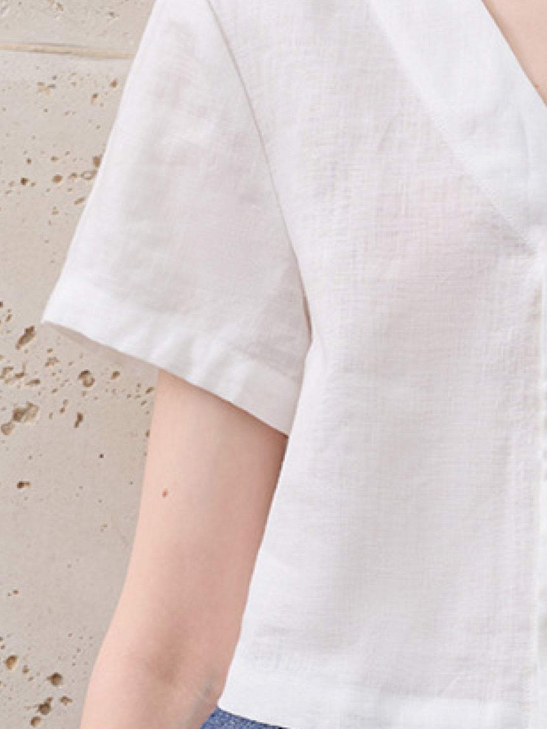 lightweight 100% linen French top with V-neckline, short sleeves, button front, and relaxed boxy fit in light khaki