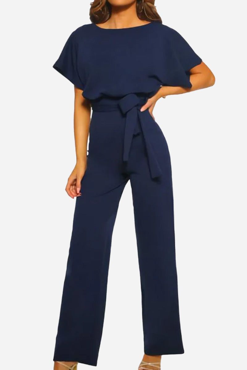 Woman wearing navy chic short-sleeved wide-leg jumpsuit with belt
