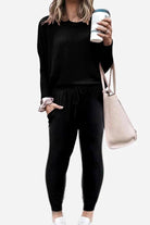 woman wearing Cozy Chic Two-Piece Sweatsuit Set with long-sleeve top and high-waisted pants with pockets