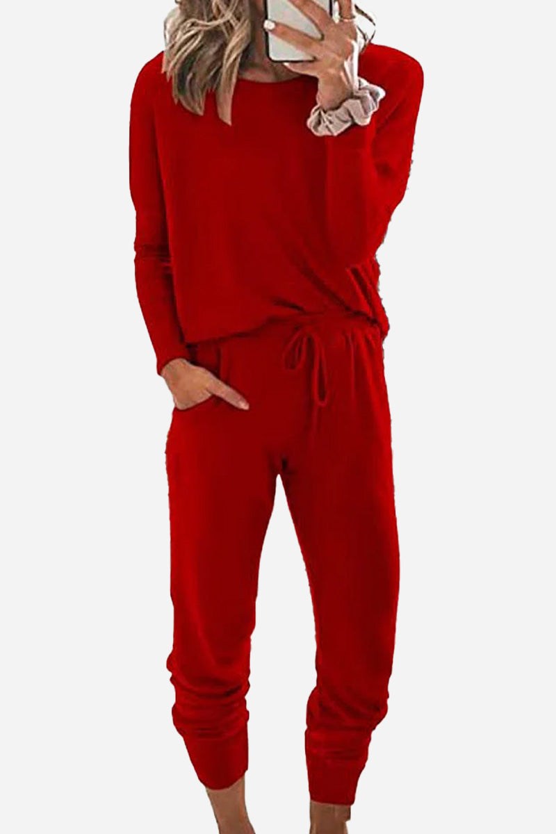 woman wearing cozy chic two-piece sweatsuit set with long-sleeve top and high-waisted pants with pockets
