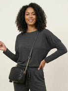 woman wearing Cozy Chic two-piece sweatsuit set with long-sleeve top and high-waisted pants with pockets