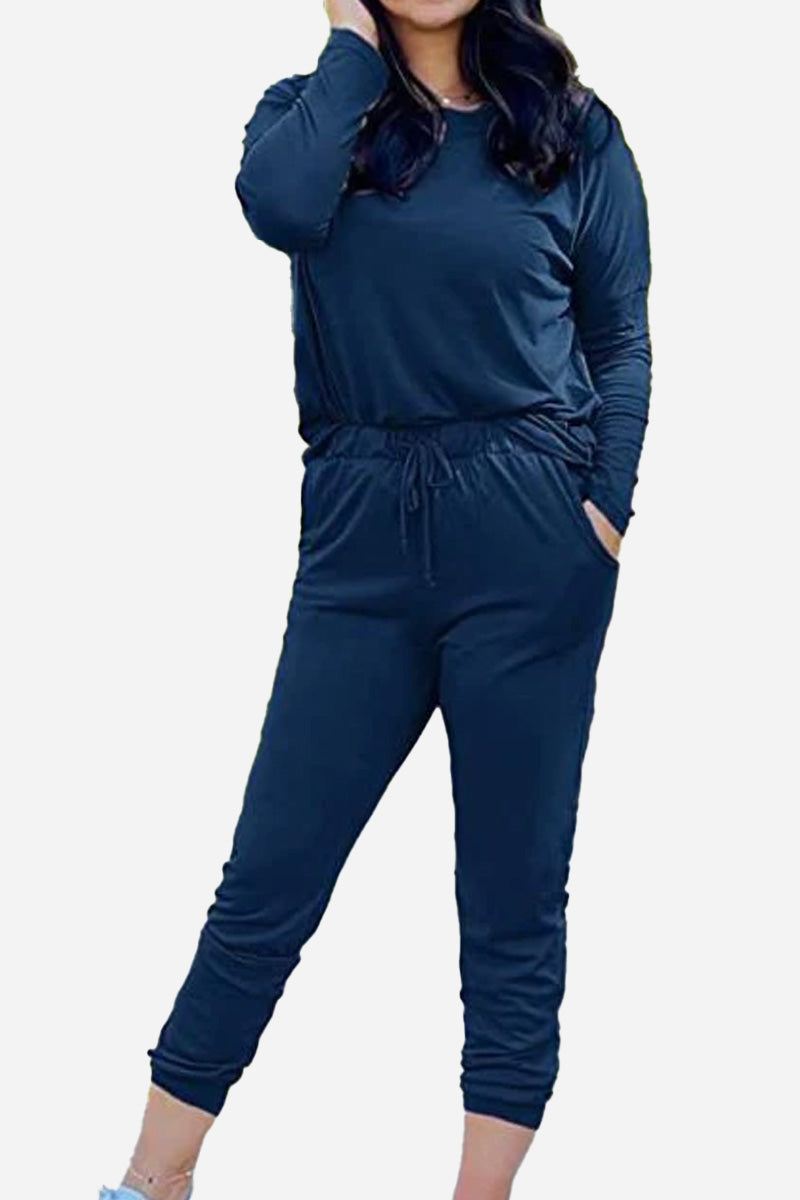 woman wearing cozy chic two-piece sweatsuit set with long-sleeve top and high-waisted pants with pockets
