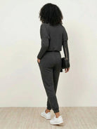 woman wearing Cozy Chic Two-Piece Sweatsuit set with long-sleeve top and high-waisted pants with pockets
