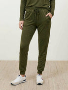 woman wearing cozy chic two-piece sweatsuit set with long-sleeve top and high-waisted pants with pockets