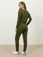 woman wearing cozy chic two-piece sweatsuit set with long-sleeve top and high-waisted pants with pockets