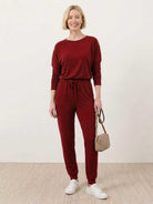 Cozy Chic Two-Piece Sweatsuit set with long-sleeve top and high-waisted pants in soft fabric for travel and everyday comfort