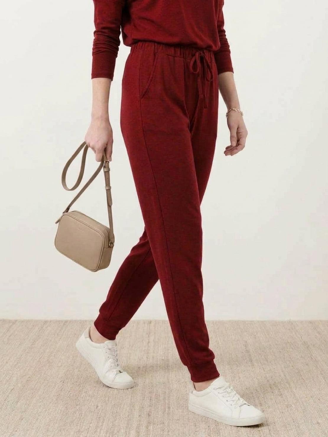 woman wearing Cozy Chic Two-Piece Sweatsuit set with long-sleeve top and high-waisted pants with pockets
