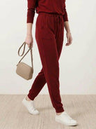 woman wearing Cozy Chic Two-Piece Sweatsuit set with long-sleeve top and high-waisted pants with pockets