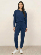 woman wearing Cozy Chic Two-Piece Sweatsuit set with long-sleeve top and high-waisted pants with pockets
