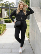 woman wearing Cozy Chic Two-Piece Sweatsuit Set with long-sleeve top and high-waisted pants with pockets