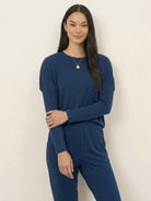 woman wearing cozy chic two-piece sweatsuit set with long-sleeve top and high-waisted pants with pockets