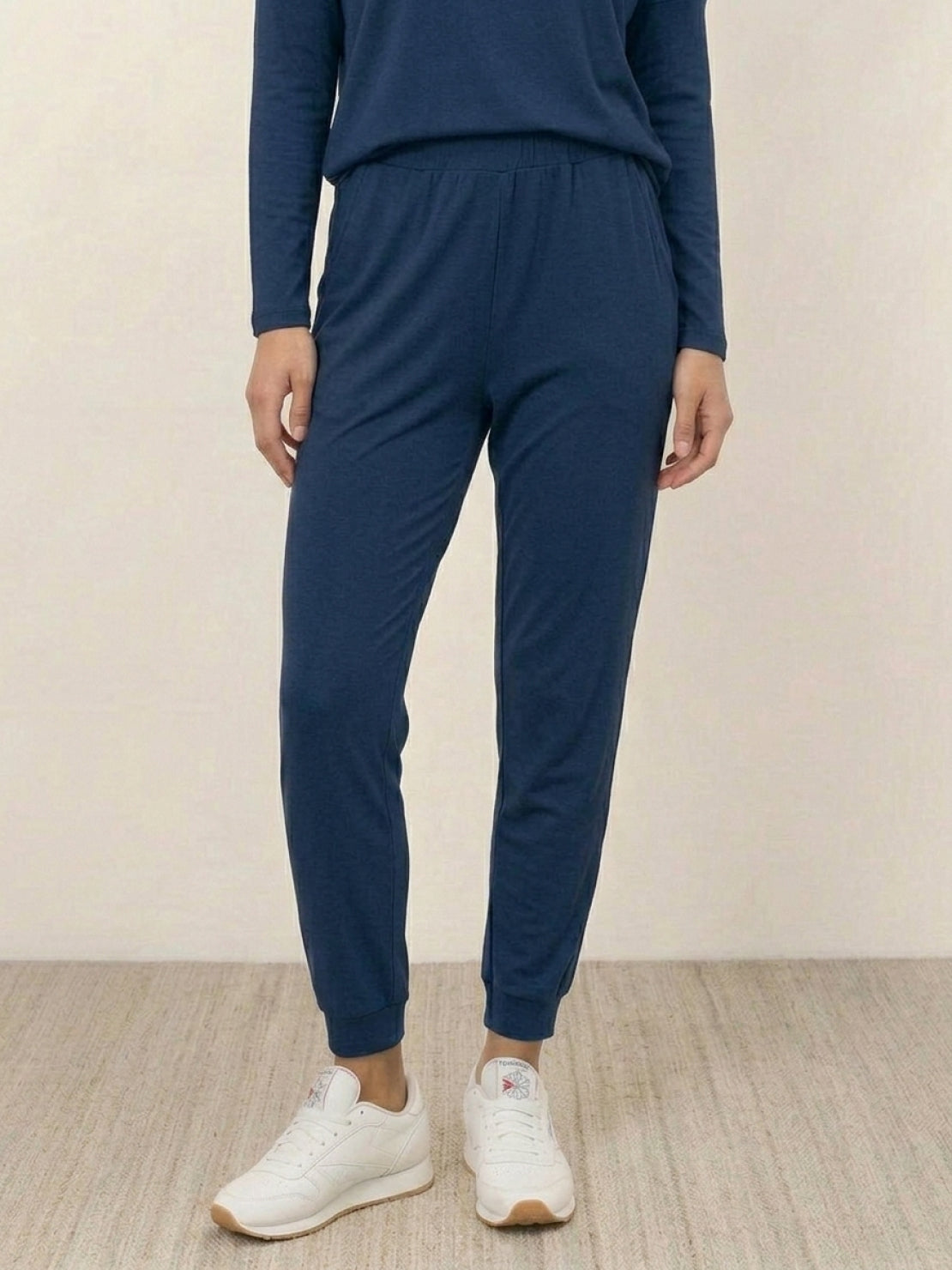 woman wearing Cozy Chic two-piece sweatsuit set with long-sleeve top and high-waisted pants with pockets