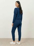 woman wearing Cozy Chic Two-Piece Sweatsuit set with long-sleeve top and high-waisted pants with pockets