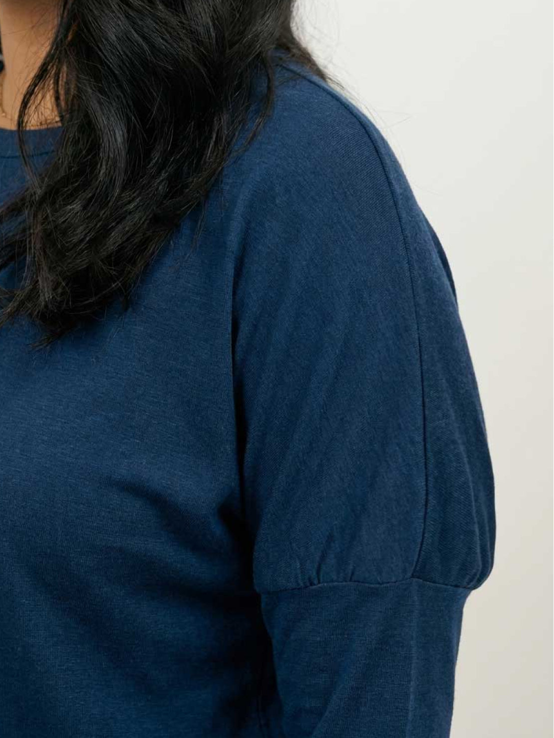 woman wearing cozy chic two-piece sweatsuit set with long-sleeve top and high-waisted pants with pockets