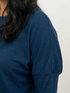 woman wearing cozy chic two-piece sweatsuit set with long-sleeve top and high-waisted pants with pockets