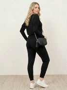 woman wearing Cozy Chic Two-Piece Sweatsuit set with long-sleeve top and high-waisted pants with pockets