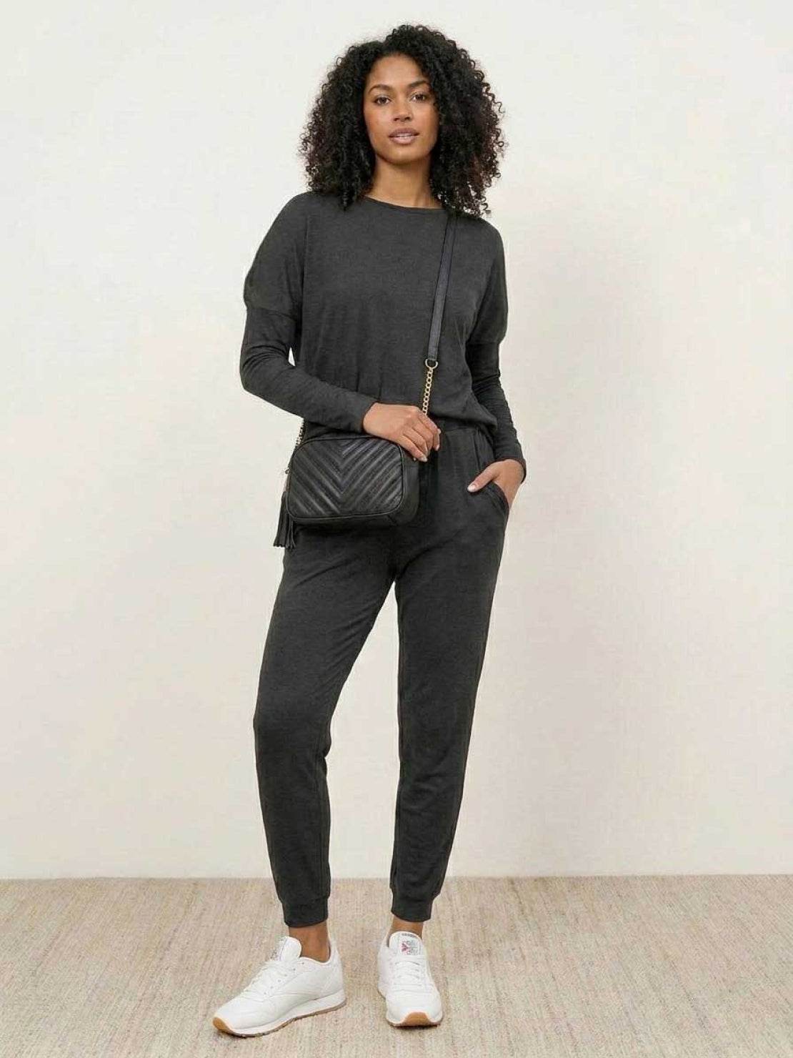 woman wearing cozy chic two-piece sweatsuit set with long-sleeve top and high-waisted pants with pockets