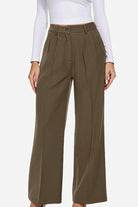 Woman wearing Classically Vogue Business Trousers in olive green with high-waist and tailored slim fit design.
