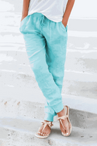 Woman wearing relaxed chic elastic ankles pants styled casually in neutral tones