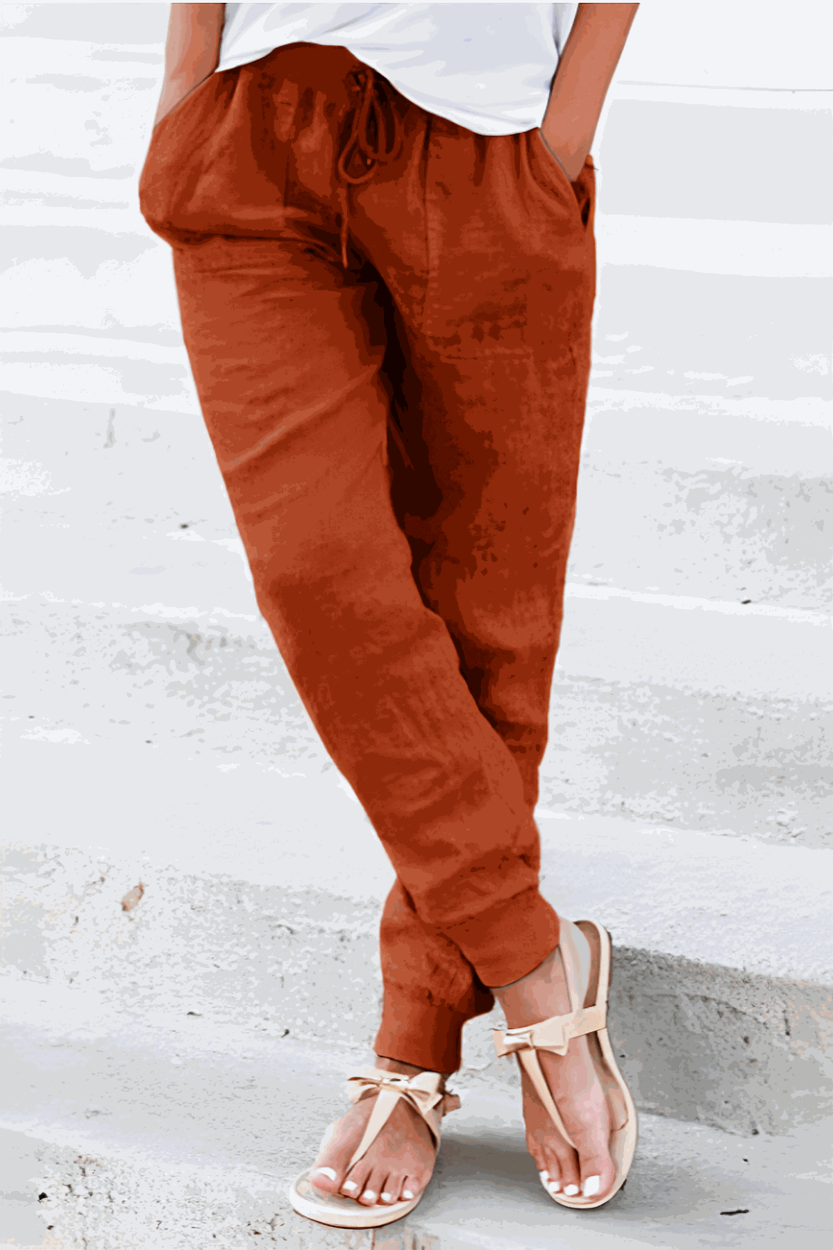 woman wearing relaxed chic elastic ankles pants with hands in pockets standing outdoors