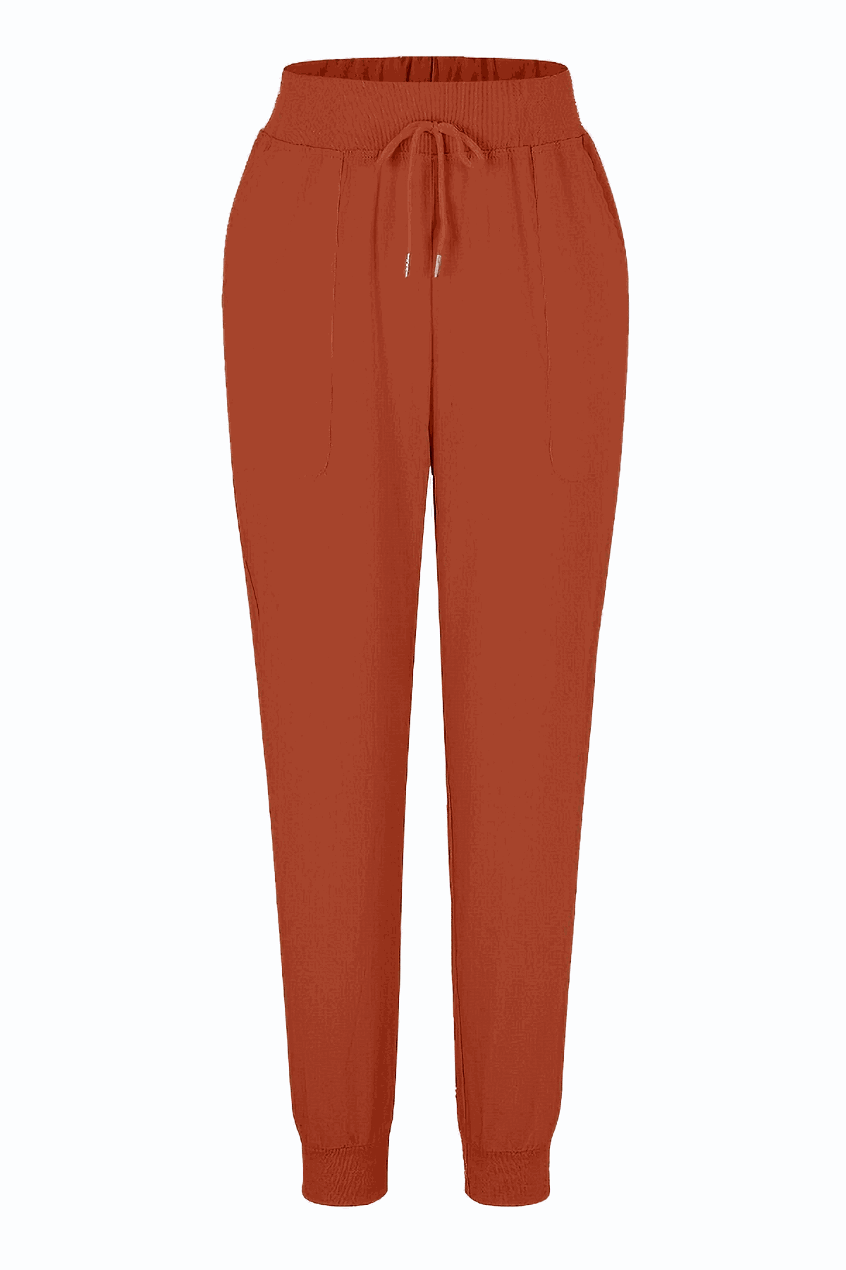 Woman wearing relaxed chic elastic ankles pants standing against a white wall