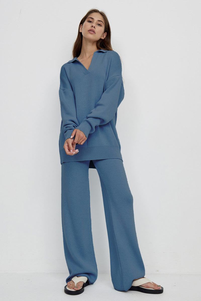 Woman wearing a blue plush and preppy two-piece travel set with polo collar and wide-leg pants