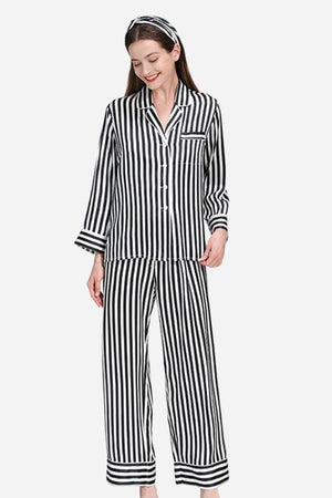 Woman wearing 100% mulberry silk striped long sleeve pajama set with matching pants and headband