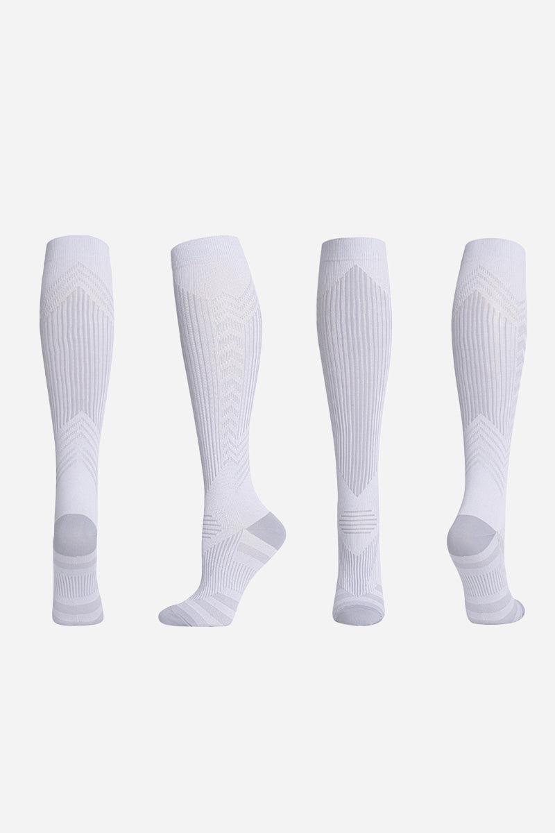 White premium compression socks shown from multiple angles for travel and leg support
