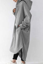 Oversized everyday buttoned hooded coat in light gray cotton-poly blend with roomy pockets and relaxed fit.