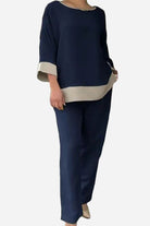 Woman wearing navy and beige dual-tone 3/4 sleeve two-piece set with relaxed fit and cotton blend fabric