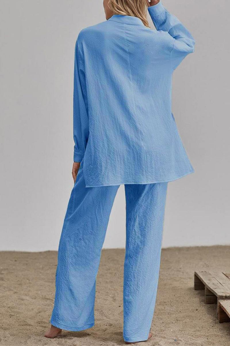 Back view of woman wearing light blue linen blend two-piece set with loose fit, long sleeves, and wide-leg pants.