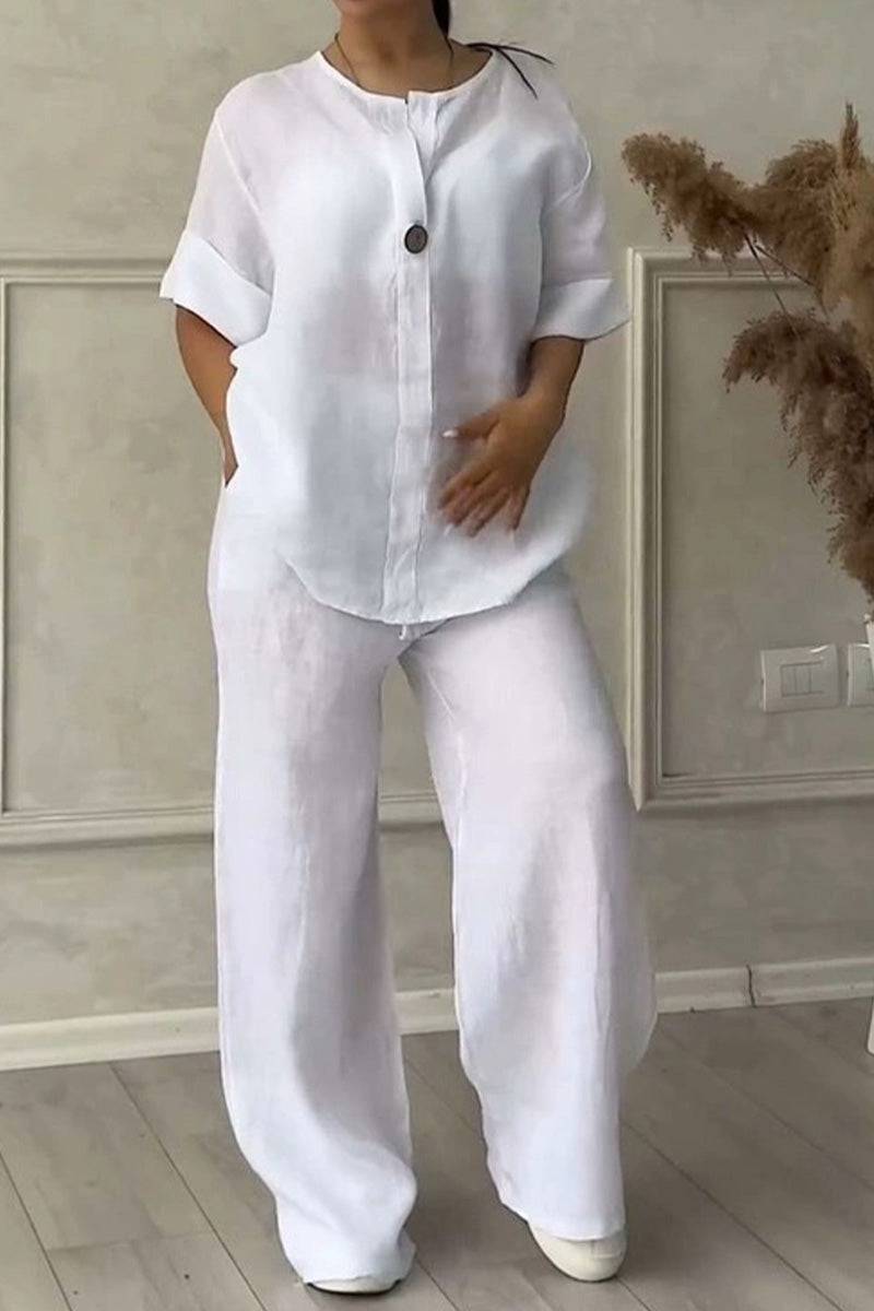 Woman wearing white pure linen two-piece casual comfort set with loose pants and buttoned top