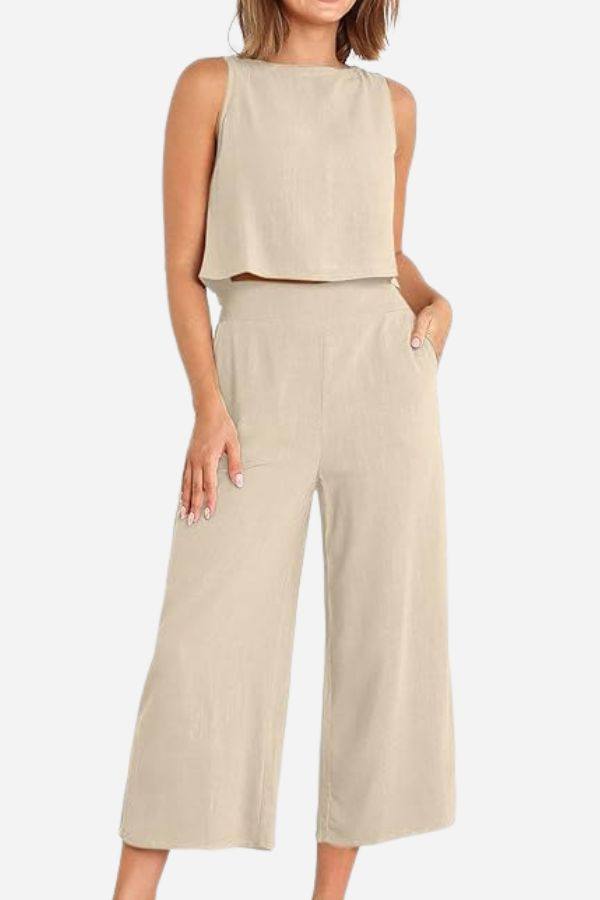 Woman wearing beige Villa Lounge Linen Set sleeveless cropped top and wide-leg pants with pockets
