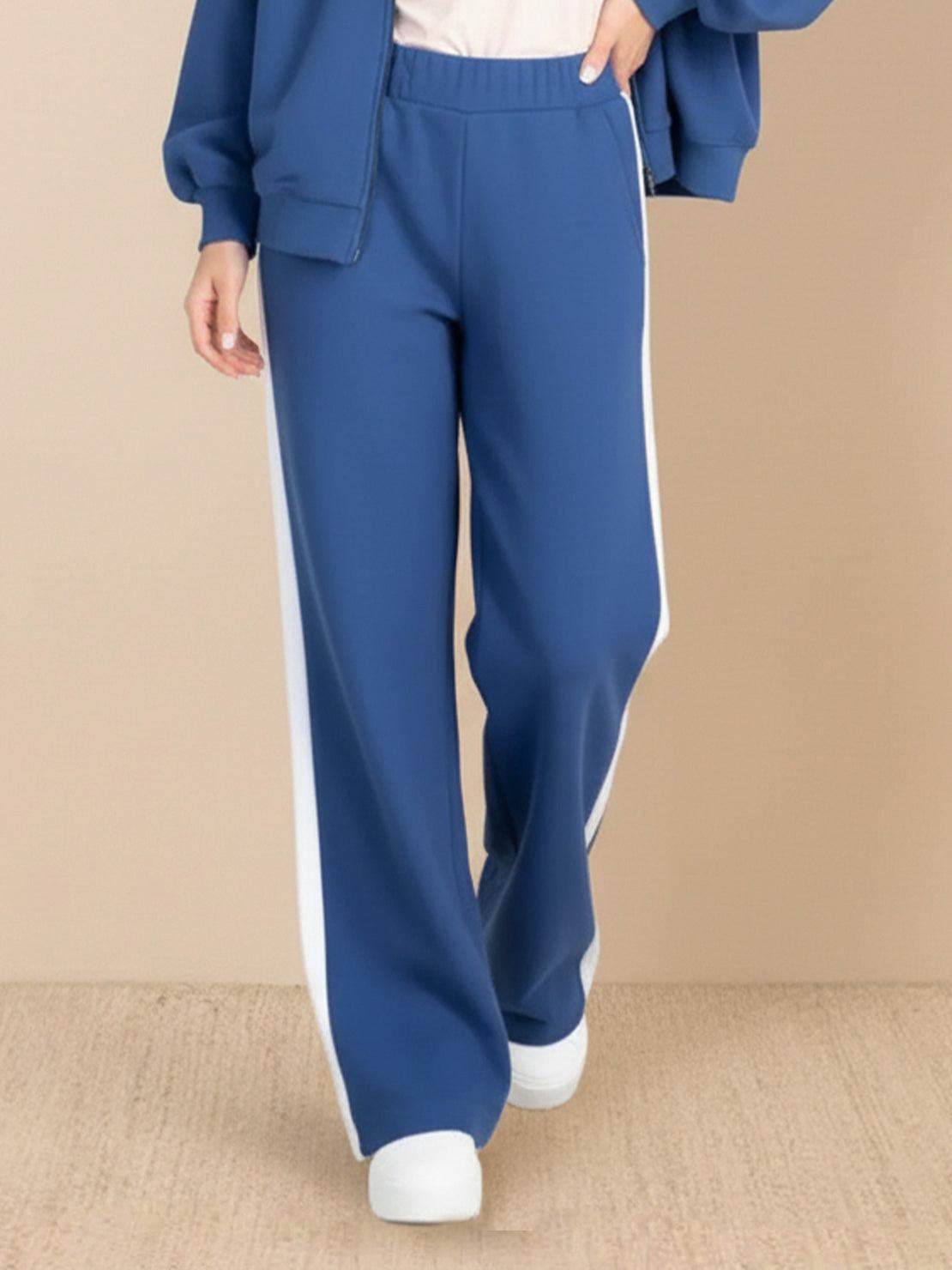 Two-piece easy airport lounge set in soft cotton-blend fabric with zip-front jacket and wide-leg pants.