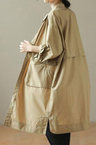 Beige Nomad Ease Oversized Shirt-Jacket with roll-up sleeves and large front pockets worn by woman.