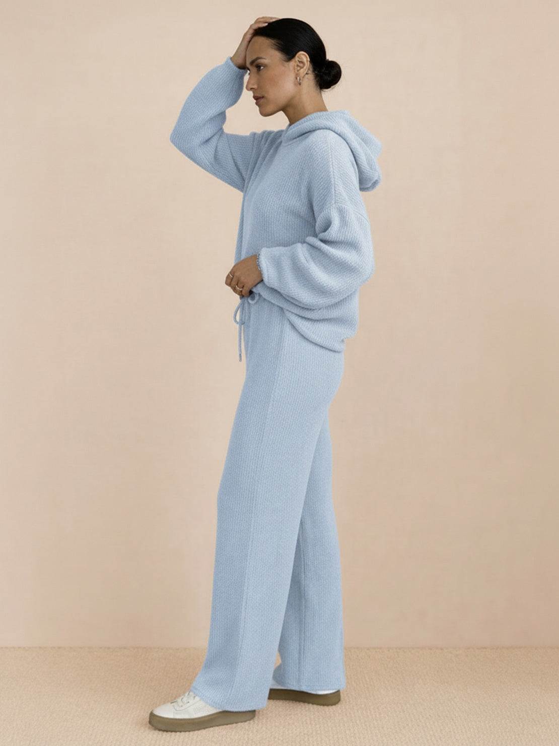 woman wearing light blue waffle-knit two-piece hoodie and pants lounge set