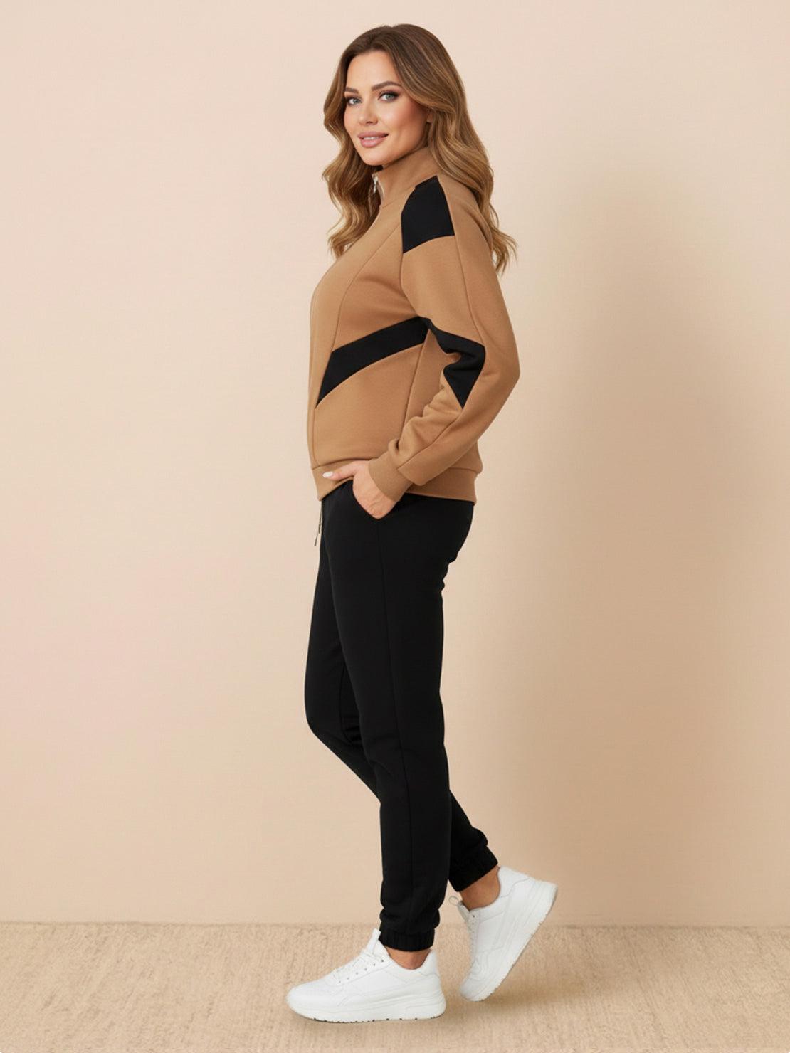 Woman wearing a colorblock comfort tracksuit with contrast curved panels and relaxed fit