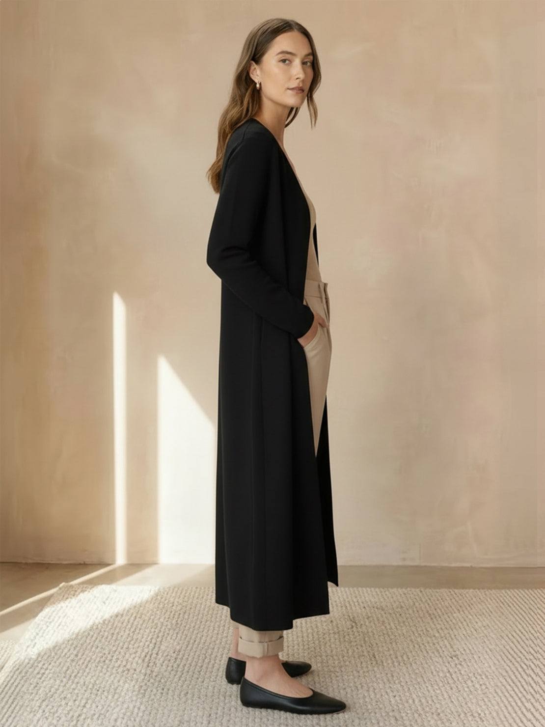 Long cardigan made of 100% Australian Merino wool with open front and patch pockets.