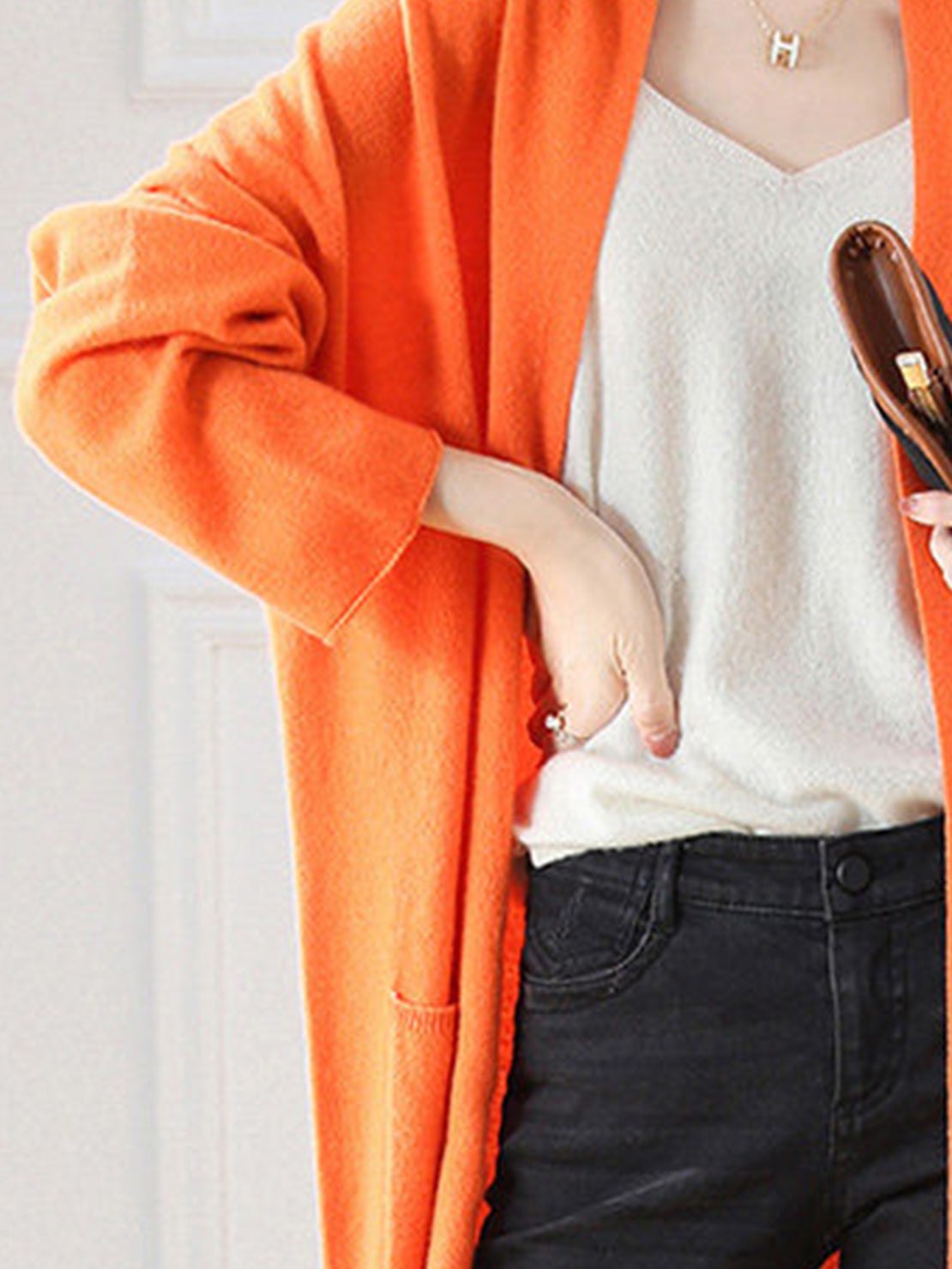 Long 100% Australian Merino Wool cardigan with open front, ribbed cuffs, front pockets, and natural temperature regulation.