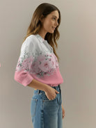 hip-length floral button-down shirt with long roll-up sleeves and shirt-tail hem