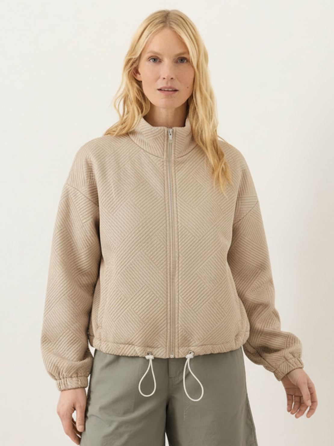 Cropped textured baseball jacket with full zipper, stand collar, elastic cuffs, and waistband, styled for casual wear and layering.