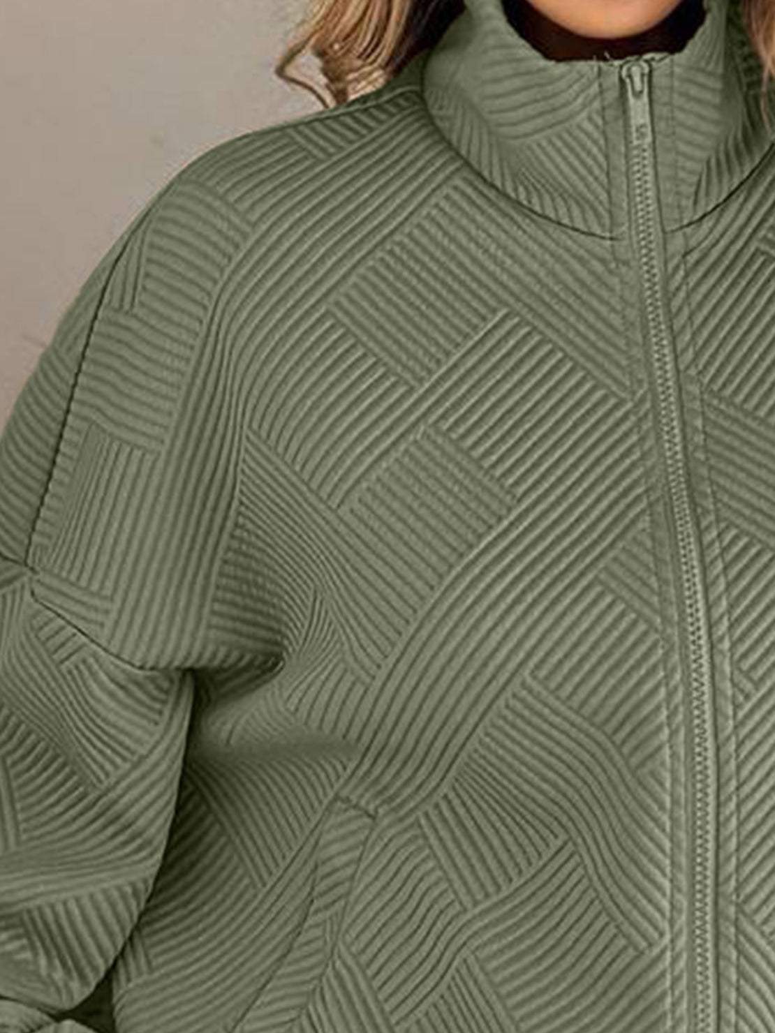 Cropped textured baseball jacket with full zip, elastic cuffs, and waistband for casual layering.