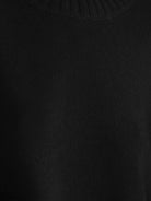 Oversized crew neck knit sweater with drop-shoulder sleeves and ribbed cuffs in neutral color