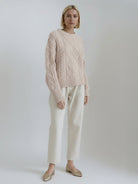 Oversized cable-knit crewneck sweater with dropped shoulders and ribbed trim